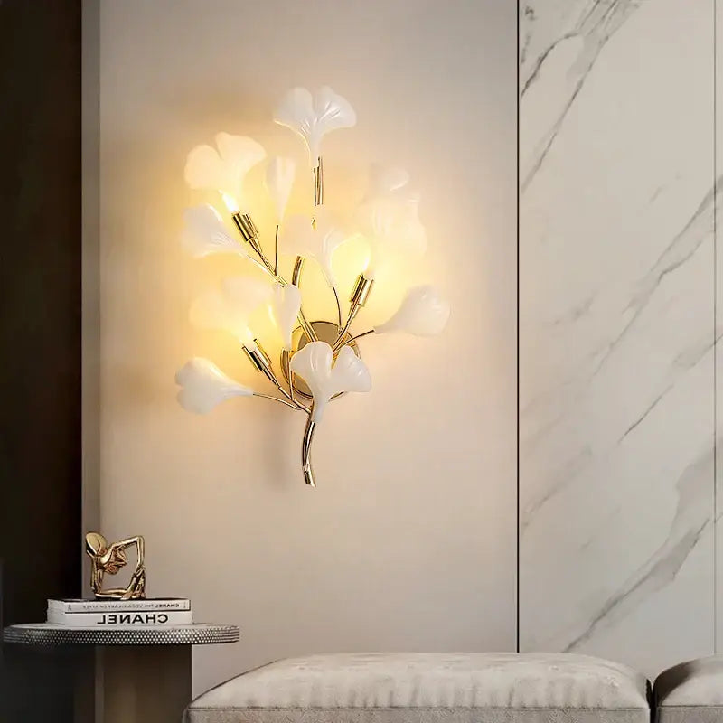 Elegant white glass ginkgo leaf wall lamp with gold-toned metal stems by DecorBites for modern luxury decor