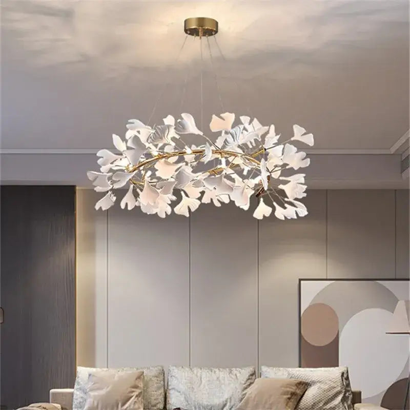 A modern white ginkgo leaves chandelier with gold-toned frame and hanging wires by decorbites ginkgo for luxury decor