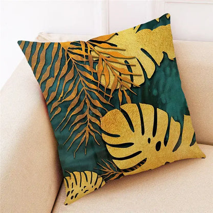 Square linen cushion cover with decorbites ginkgo leaves pattern in gold and teal on textured fabric background