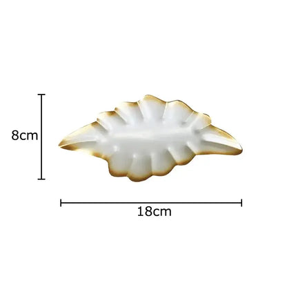 White ceramic leaf-shaped serving tray with gold-trimmed edges for decorbites ginkgo leaves wall decor