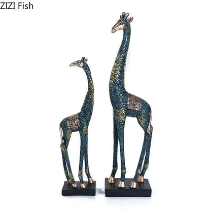 Two ornate dark teal and gold giraffe resin statues with patterned finish ideal as resin statue ornaments for decor