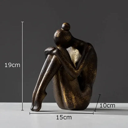 Bronze-colored abstract resin decorbites girl statue with textured surface seated human form for bookends decor