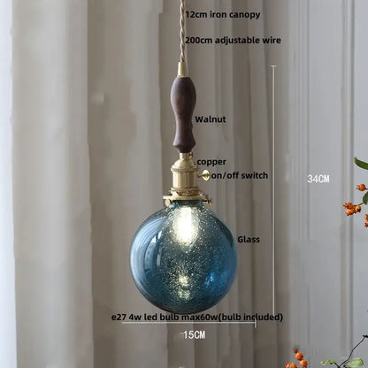 Blue textured glass pendant lamp with walnut-finished iron canopy and brass switch from decorbites glabe led pendant series