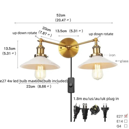 Brass-finished wall sconce with frosted glass shades and pull chain switch featuring Edison-style bulbs for bedroom use