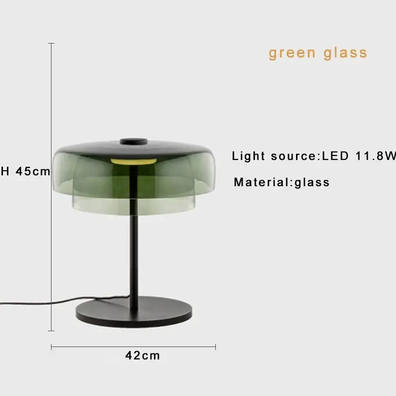 A modern decorbites glass amber green table lamp with layered glass shade and black metal base for bedroom decor
