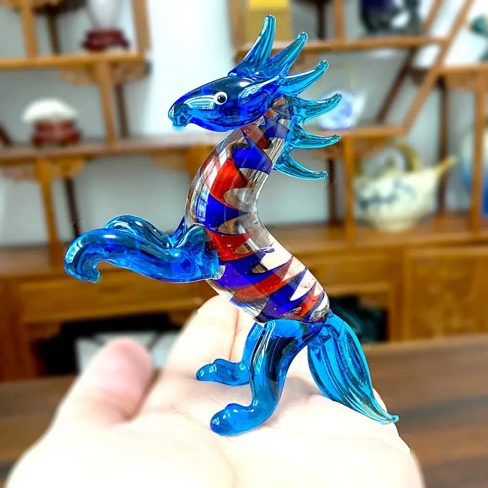 Translucent blue glass animal figurine dragon with red and purple swirling patterns from decorbites glass collectibles