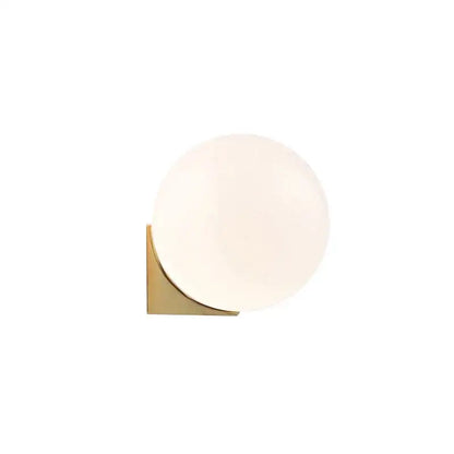A sleek decorbites glass ball wall lamp with frosted glass globe and polished brass base for bedroom lighting