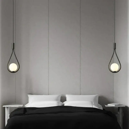 Black teardrop pendant lights with frosted glass globes hang above bed in decorbites glass ball brass wall lamp design