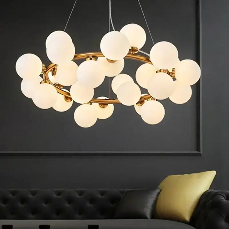 Gold-toned DecorBites glass ball ceiling chandelier with frosted glass globe bulbs for dining and living room decor