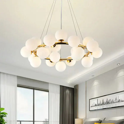 Gold-toned DecorBites glass ball ceiling chandelier with frosted glass globe bulbs for dining and living room decor