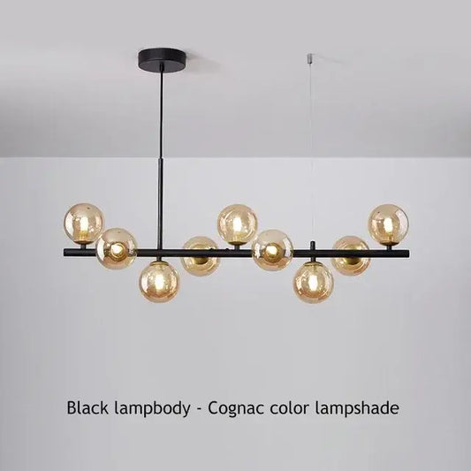 Black metal DecorBites™ ball ceiling chandelier with multiple amber-tinted glass globe shades for home lighting
