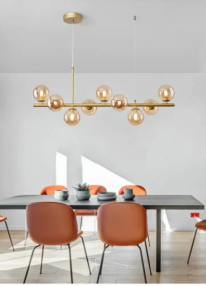 Gold-toned DecorBites™ ball ceiling chandelier with amber glass globe bulbs and brass rod for elegant home lighting