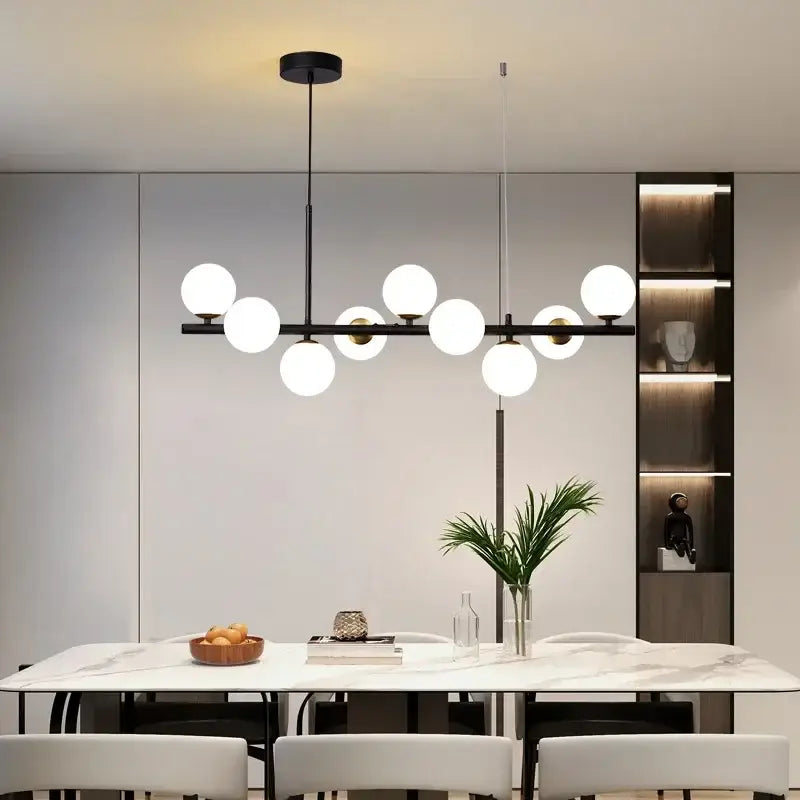 Modern black metal ball ceiling chandelier with spherical white glass globe lights for home lighting by DecorBites™