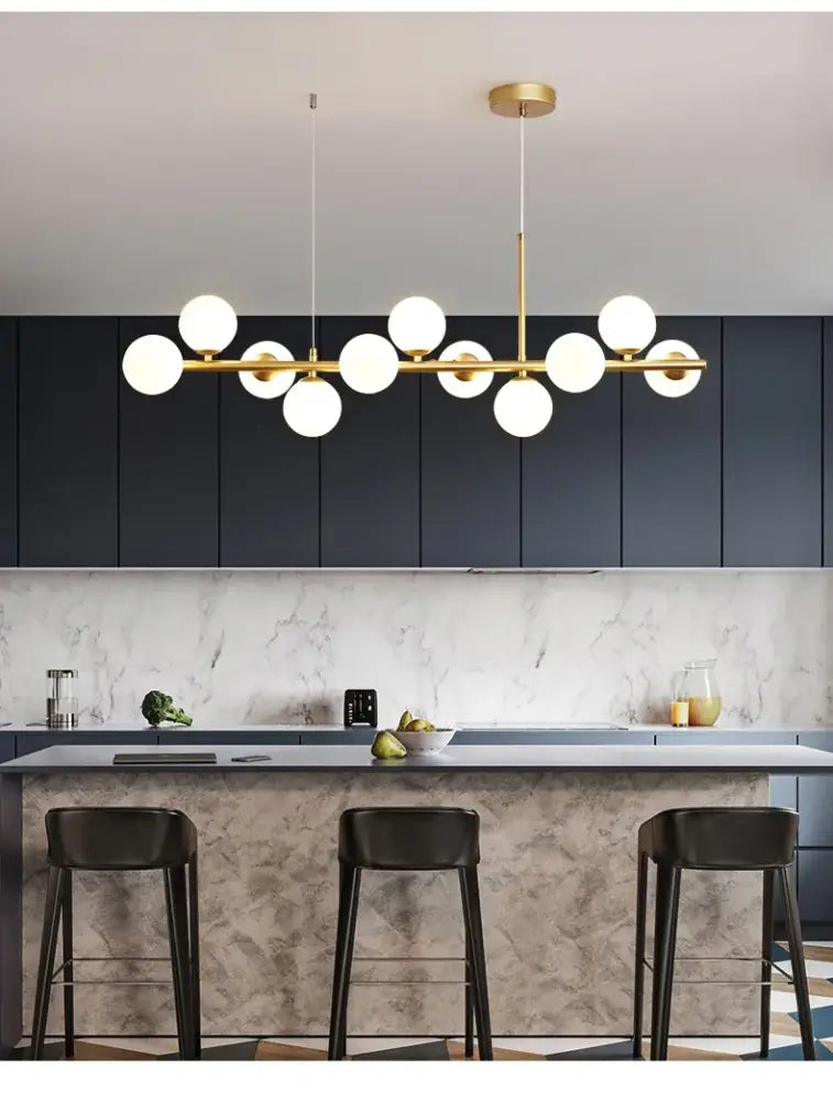 Modern gold-toned glass ball ceiling pendant light with multiple white spherical glass bulbs in linear design by decorbites