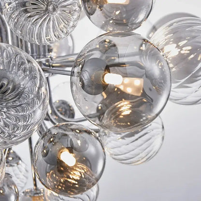 A decorbites glass ball ceiling chandelier with clear textured glass spheres and a chrome frame for living spaces