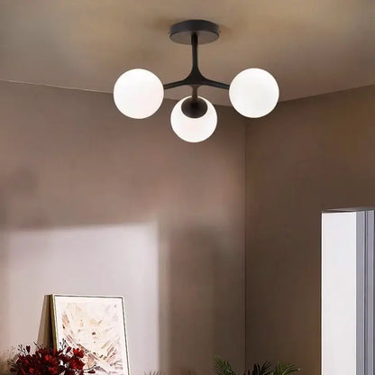 Modern black metal DecorBites glass ball ceiling chandelier with three frosted glass globe bulbs for living room