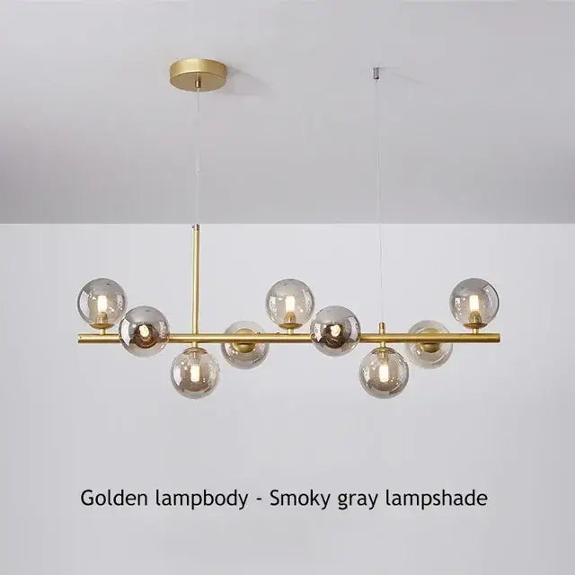 Golden DecorBites™ glass ball chandelier with smoky gray glass globe shades on a polished brass frame for dining room