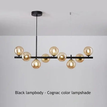 Black metal DecorBites™ glass ball chandelier with amber-tinted glass globe shades for home lighting