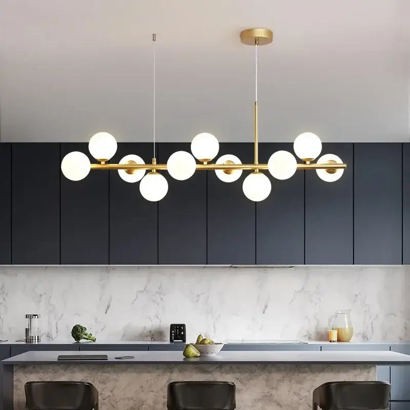 DecorBites™ glass ball chandelier with gold-toned frame and multiple white glass balls in linear modern design