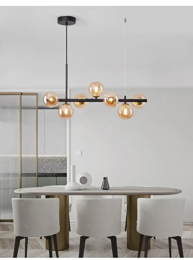 Modern black metal DecorBites glass ball chandelier featuring warm amber glass globe bulbs for home lighting
