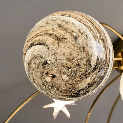 A decorbites glass ball chandelier featuring a marbled glass ball with beige, brown, and black patterns for kids room and living room