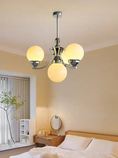 Chrome-finished decorbites glass ball chandelier with three warm glowing spherical glass shades for modern room decor