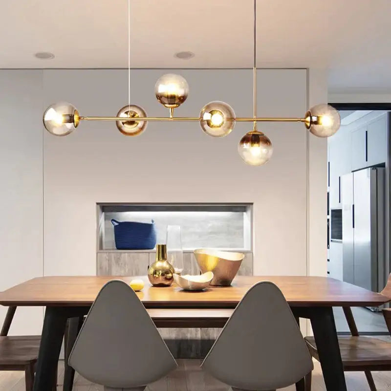 Gold-toned decorbites glass ball chandelier with spherical glass globes suspended by cords for modern kitchen and loft