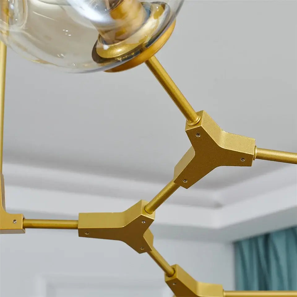 Gold-toned glass ball led chandelier with geometric design and clear glass globe fixtures by DecorBites Nordic style