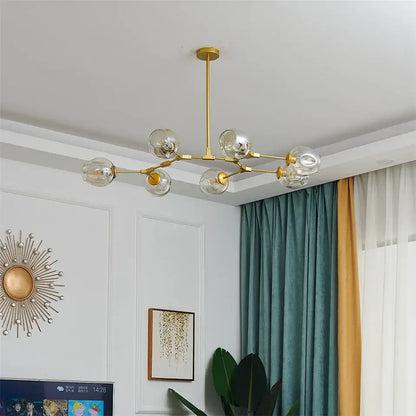 Gold-toned DecorBites glass ball led chandelier with six clear glass globes in a modern nordic style design