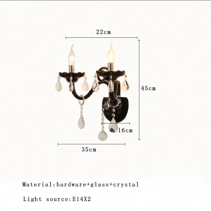 Black wrought iron wall sconce with two candle lights and crystal pendants complementing decorbites glass branch chandelier