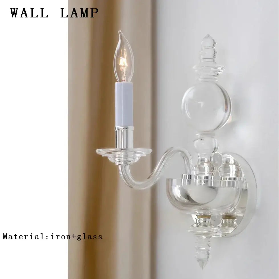 Clear glass wall lamp with silver-toned iron base and candle-style bulb from decorbites glass branch chandelier collection