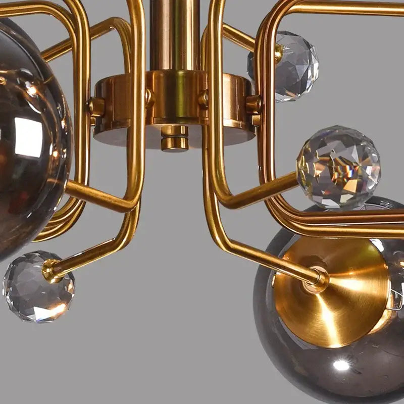 Gold-toned decorbites glass bubble chandelier with faceted crystal spheres and dark smoked glass globes for living room light