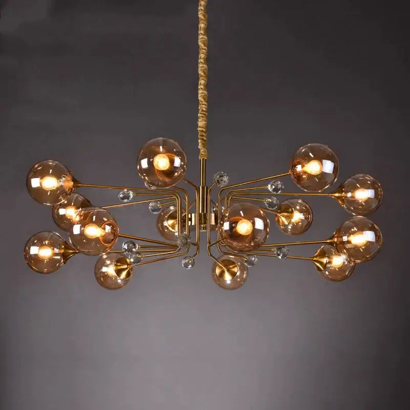 Gold-toned decorbites glass bubble chandelier with amber glass globe bulbs and clear crystal accents for living room lighting
