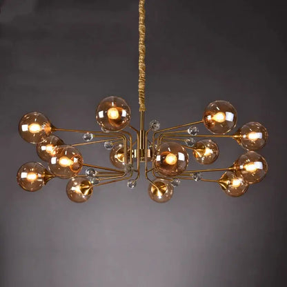Gold-toned decorbites glass bubble chandelier with amber glass globe bulbs and clear crystal accents for living room lighting