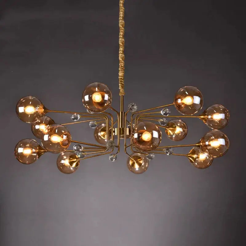 Gold-toned decorbites glass bubble chandelier with amber glass globes and clear crystal accents for living room lighting