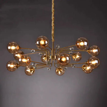 Gold-toned decorbites glass bubble chandelier with amber glass globes and clear crystal accents for living room lighting