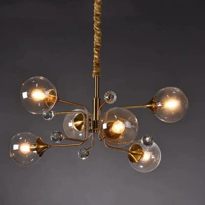 Brass decorbites glass bubble chandelier with clear glass globe shades and crystal accents hanging from twisted rope