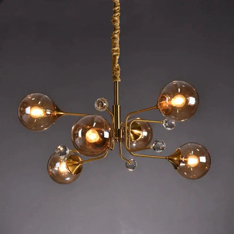 Gold-toned decorbites glass bubble chandelier with amber glass globes and crystal accents for living room lighting