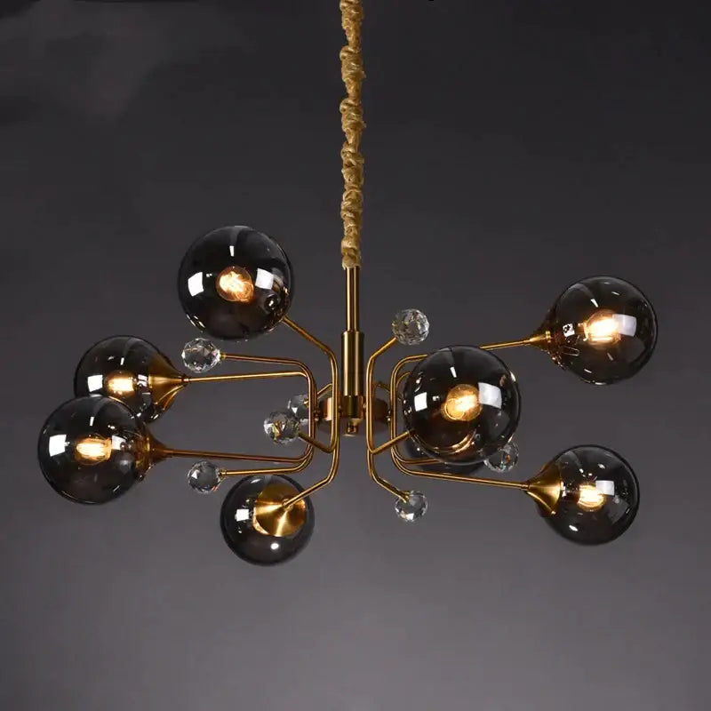 Gold-toned decorbites glass bubble chandelier with six dark smoked glass globes and clear crystal accents for living room light