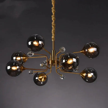 Gold-toned decorbites glass bubble chandelier with six dark smoked glass globes and clear crystal accents for living room light