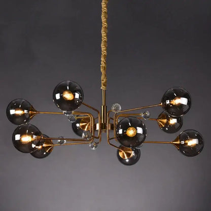 Gold-toned decorbites glass bubble chandelier with dark smoked glass globes and clear crystal accents for living room lighting