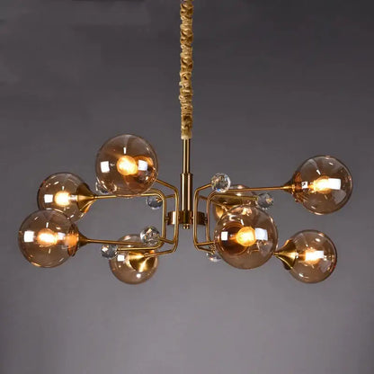 Gold-toned decorbites glass bubble chandelier with amber glass globes and crystal accents for living room lighting