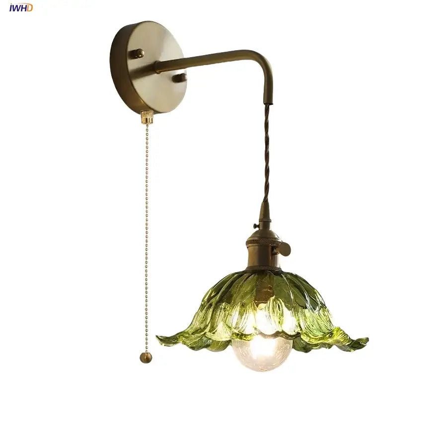 Antique brass wall sconce with copper green flower leaf-shaped glass shade and pull chain for elegant lighting