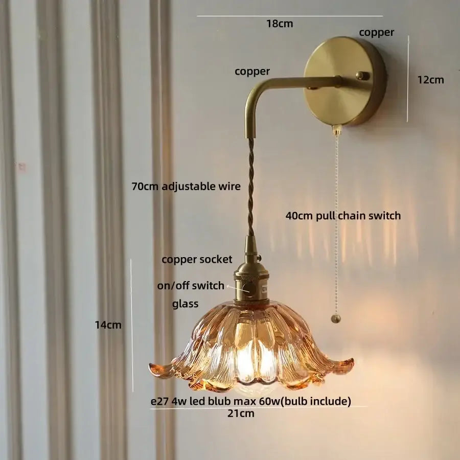 A warm amber glass copper green flower led wall sconce with fluted design and copper-finished hardware by decorbites