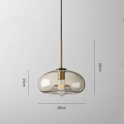 DecorBites™ glass pendant lights with translucent amber glass shade and brass accents suspended by black cord