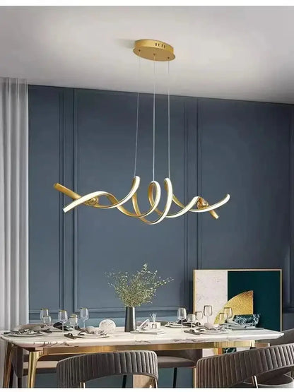 Gold-toned DecorBites™ modern abstract glass pendant lights with sleek flowing design and minimalist circular mount