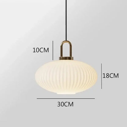 Cream-colored ribbed glass decorbites glass stripe pendant light with brass metal suspension for dining room use