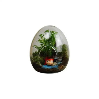 DecorBites™ high quality glass egg-shaped terrarium with transparent design housing green plants and red accessory figure