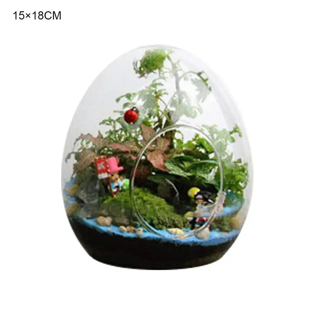 DecorBites™ high quality glass egg-shaped terrarium with miniature greenery moss and decorative figurines inside