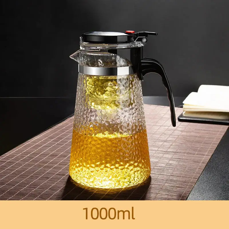 Clear hammered glass tea maker with black lid handle silver rim featuring DecorBites glass tea filter for brewing perfect tea